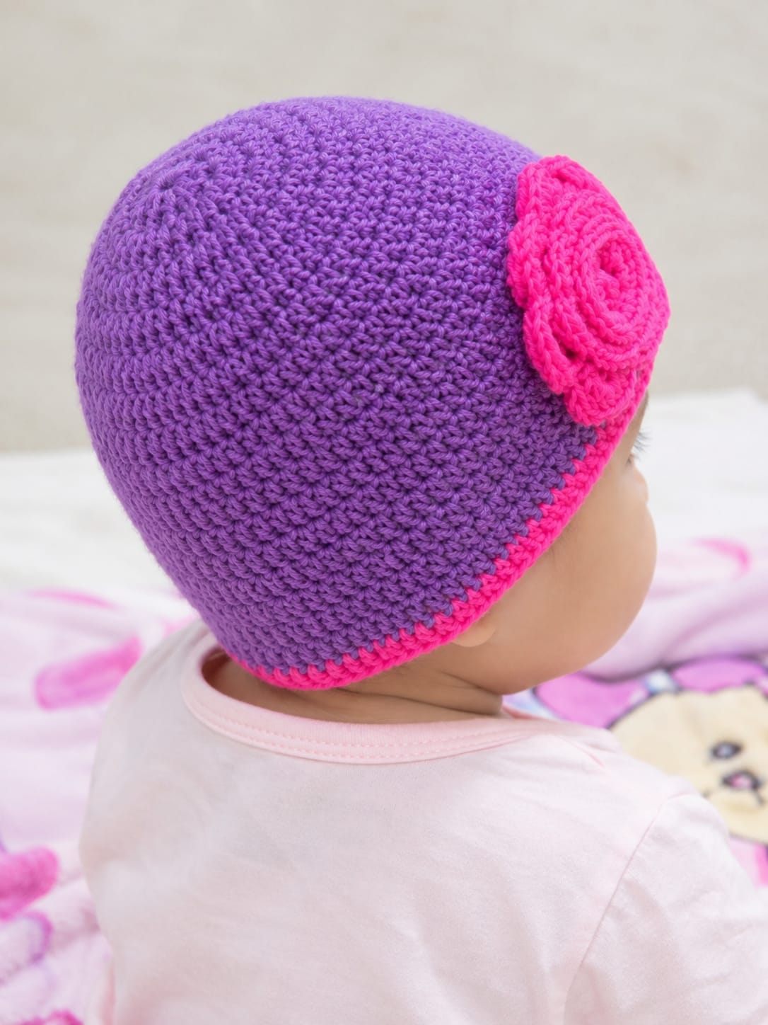 Handmade Crochet Woolen Baby Cap โ Purple Knit with Pink Flower